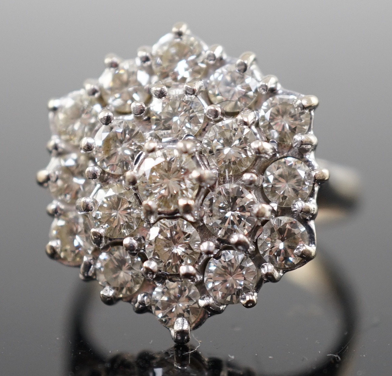 An 18ct white gold and diamond set hexagonal cluster ring